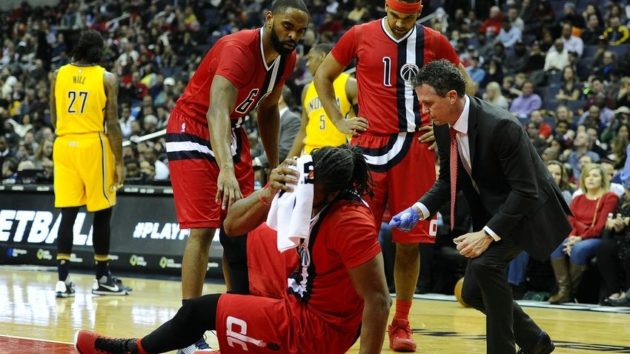 Mar 5, 2016; Washington, DC, USA; Washington Wizards center Nene Hilario (42) is tended to by a team trainer after suffering an injury against the Indiana Pacers during the first half at Verizon Center. Mandatory Credit: Brad Mills-USA TODAY Sports